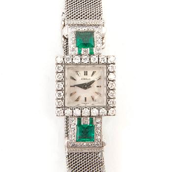 Gübelin bracelet watch in 950 platinum with round brilliant-cut and single-cut diamonds as well as step-cut emeralds.