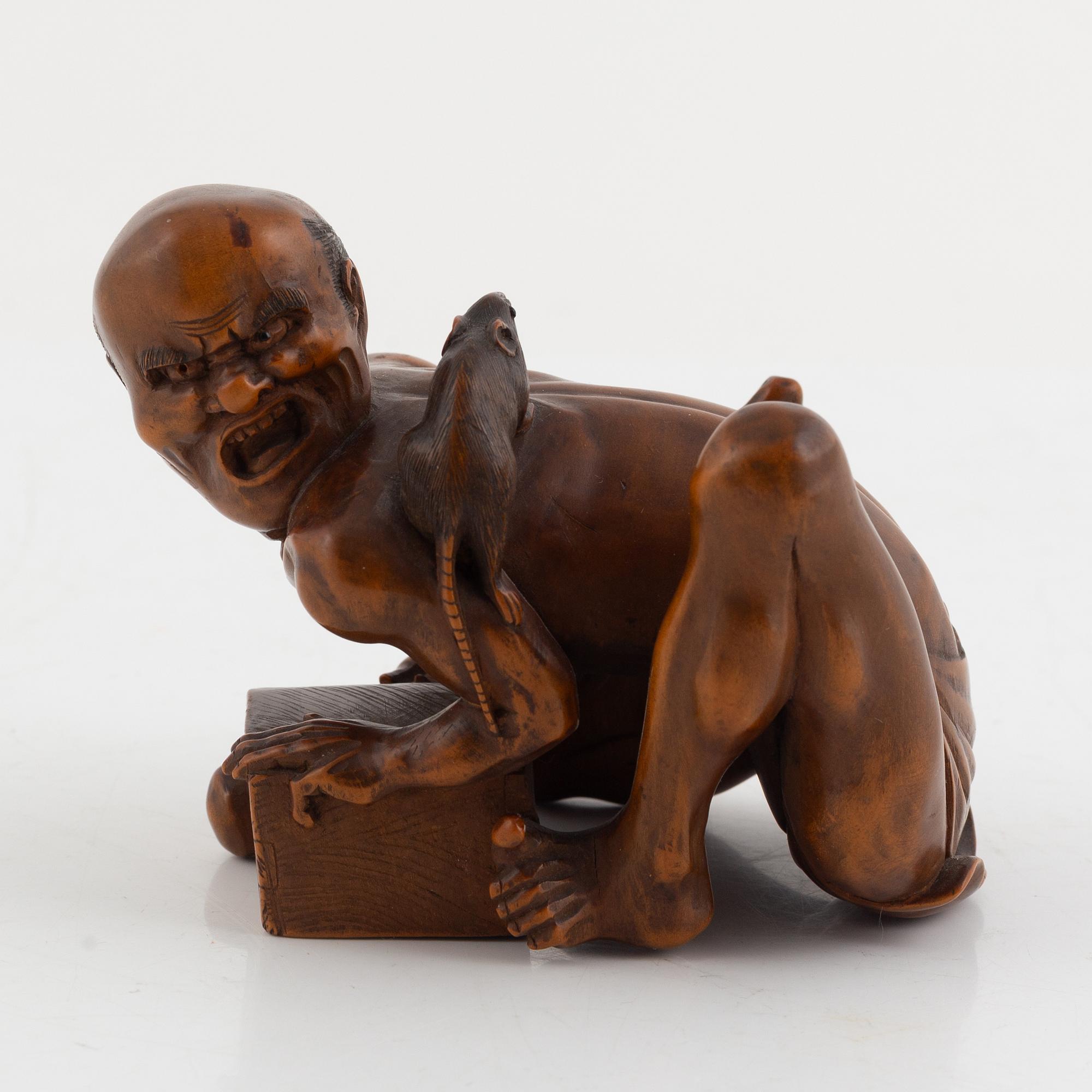 A Japanese mei boxwood okimono of a rat catcher. Meiji period.