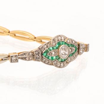 An 18K white and red gold bracelet set with emeralds between rose cut and old cut diamonds.