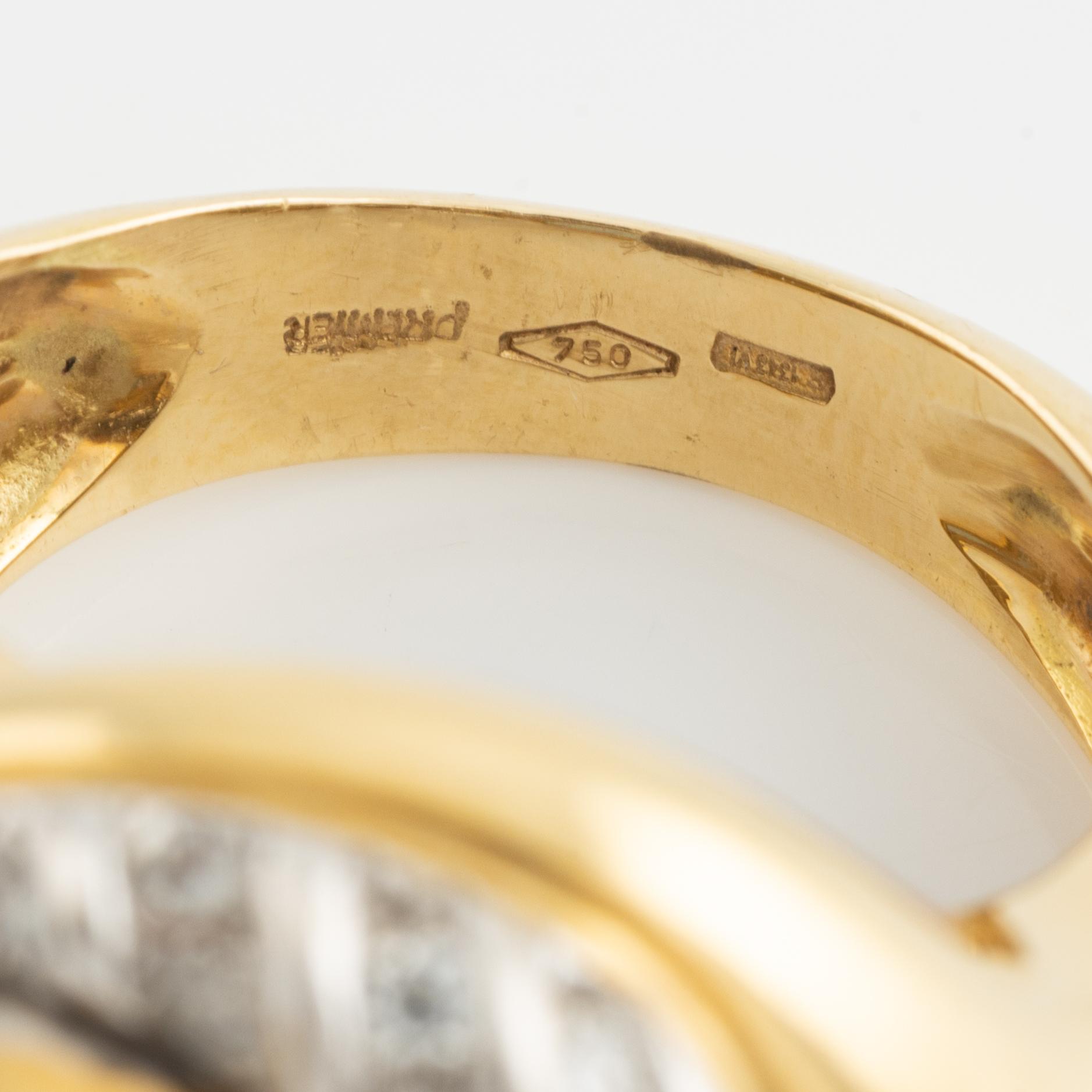 18K gold and heart shaped blue topaz and white stones.