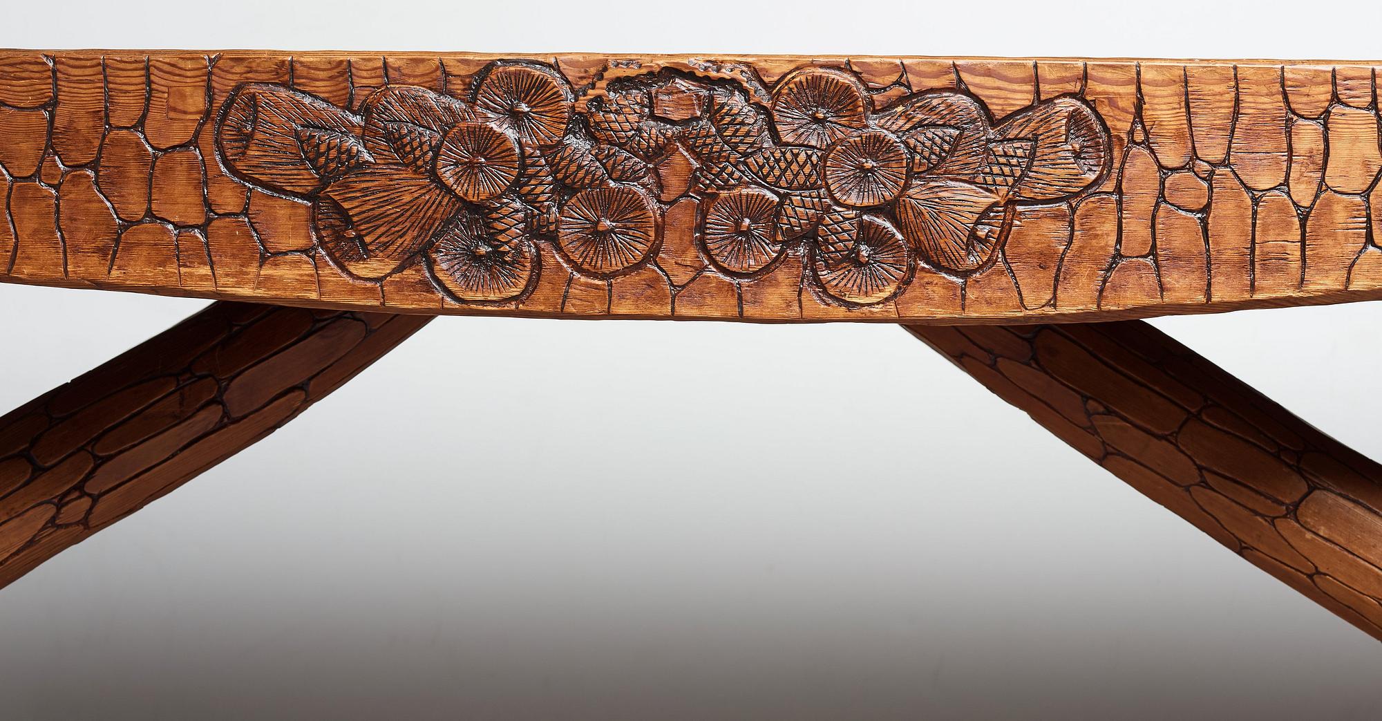 Gustaf Fjaestad, an Art Nouveau carved pine table, Arvika Sweden 1914, a double to the table in the Thiel Collection,