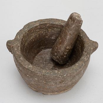 A llimestone mortar and pestle, 18th/19th Century.