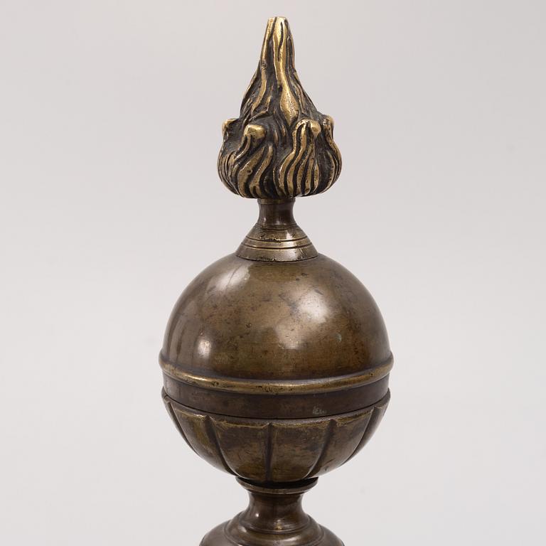 A pair of brass andirons, first half of the 20th century.