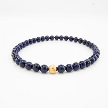 Ole Lynggaard, Necklace clasp in 18K gold with two necklaces of lapis lazuli, clasp design by Charlotte Lynggaard.