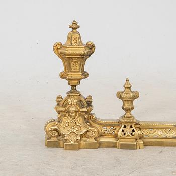 A pair of French Louis XVI style metal fire dogs, 20th century.