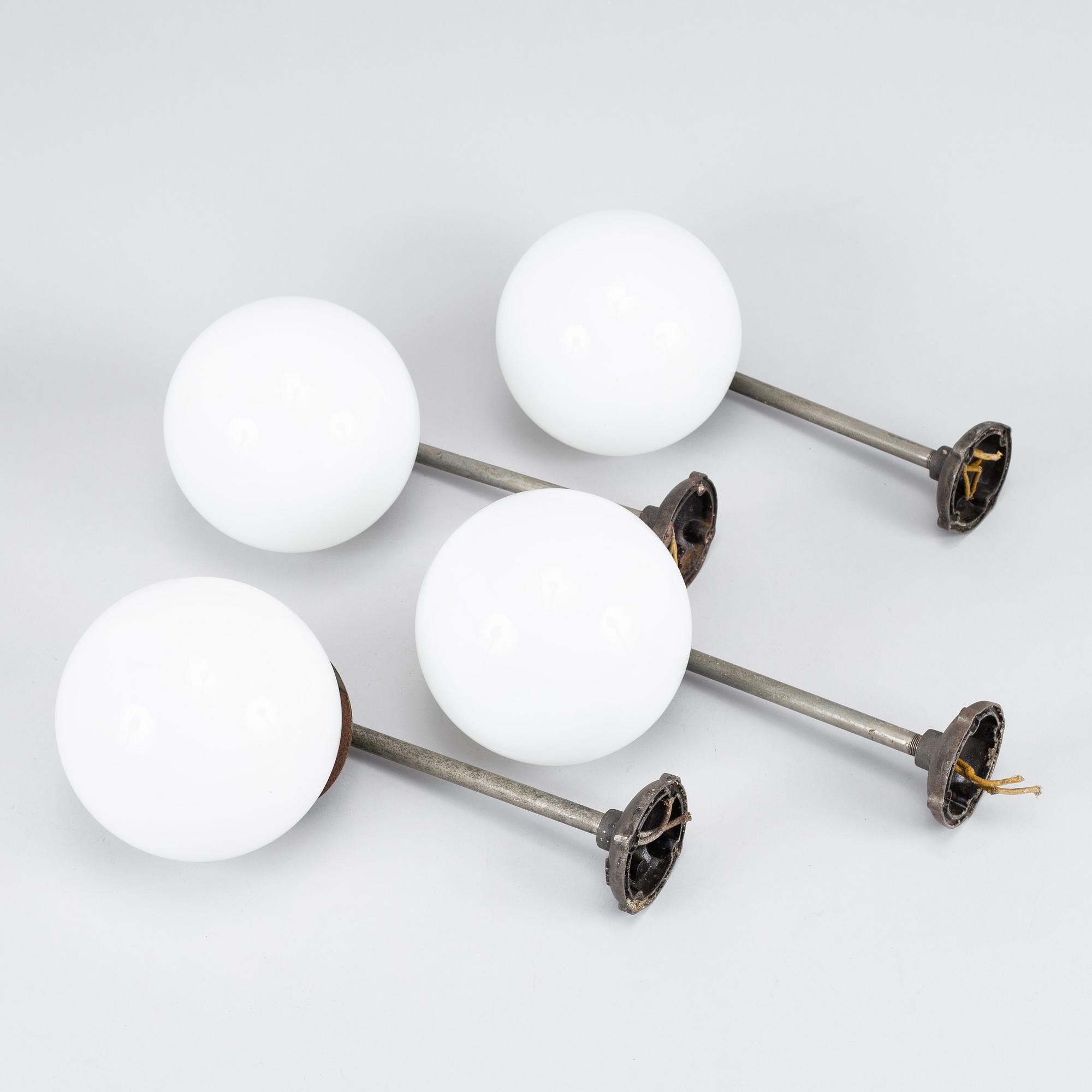A set of four metal wall lights, first half of the 20th century.