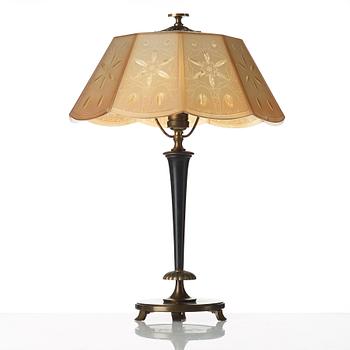 A 1920's patinated metal, lacquered wood, etched och cut glass table lamp, unknown designer, 1920's.