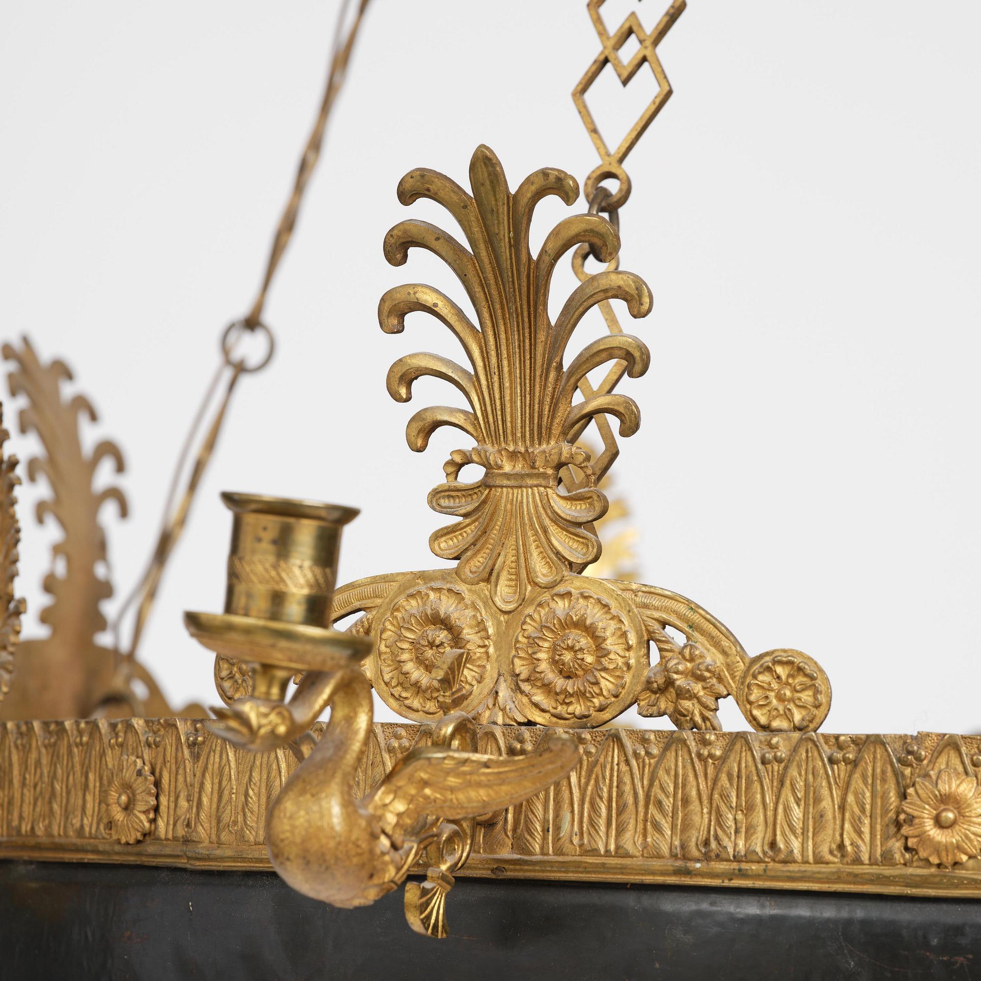 A presumably Russian Empire gilt and patinated bronze nine-branch chandelier, 19th century.