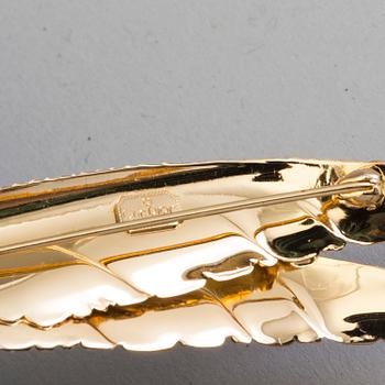 CHRISTIAN DIOR, a gilded brooch.