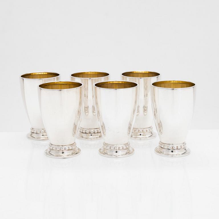 A set of six vodka cups, five napkin rings, a champagne whisk, and a tong, silver, Turku and Hämeenlinna, 1938, 1970.