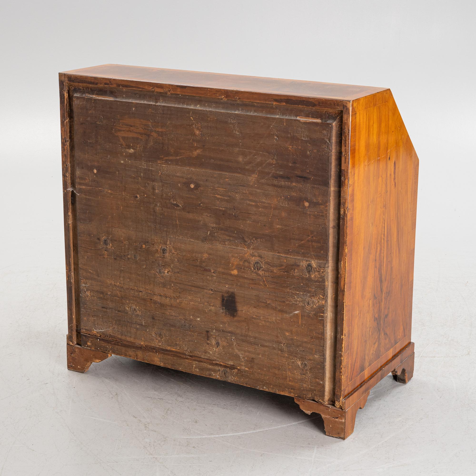 A rococo walnut-veneered and gilt-brass mounted secretaire, later part of the 18th century.
