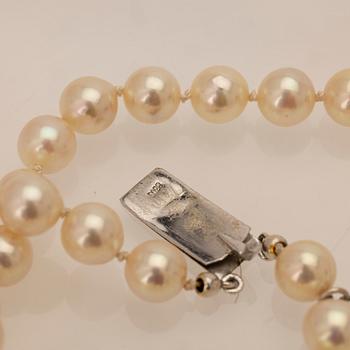 Two-row cultured pearl necklace with a silver and glass clasp.