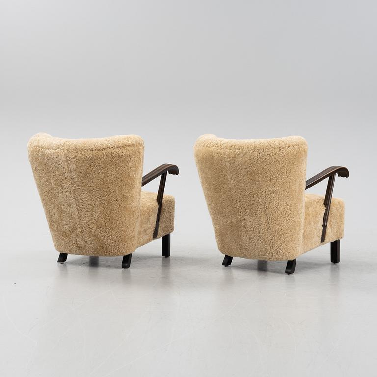 A pair of lounge chairs with new sheepskin upholstery, Denmark, 1930's/40's.