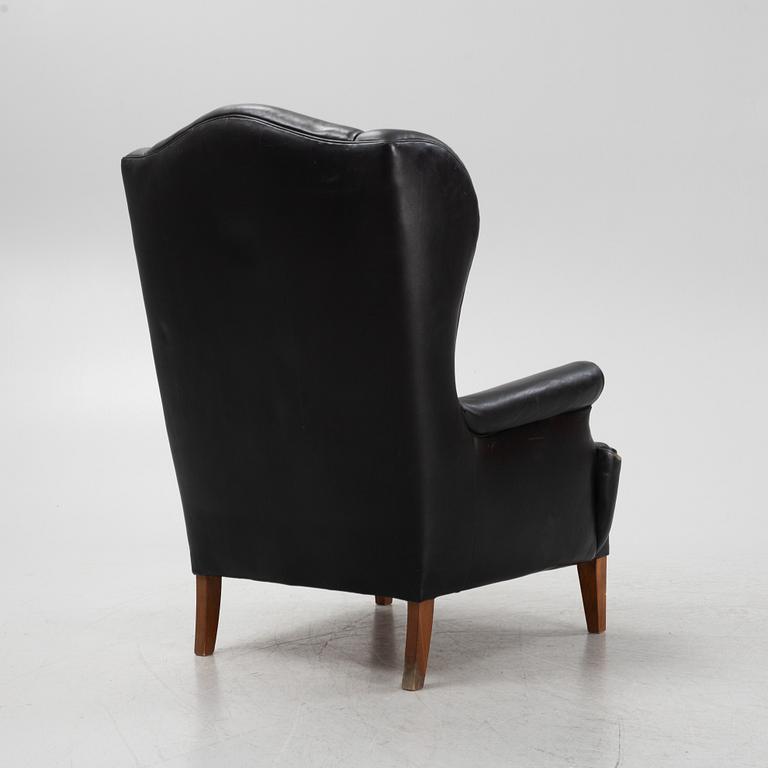 A leather upholstered wingback chair, 20th Century.