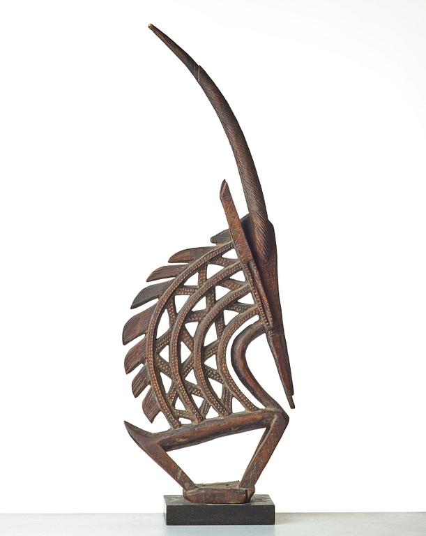 A SCULPTURE, a headdress, Tshiwara/Ciwara (stylized male antelope), wood, the Bambara tribe, Mali, h. 94 cm. On a base.