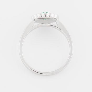 An emerald and brilliant cut diamond ring.