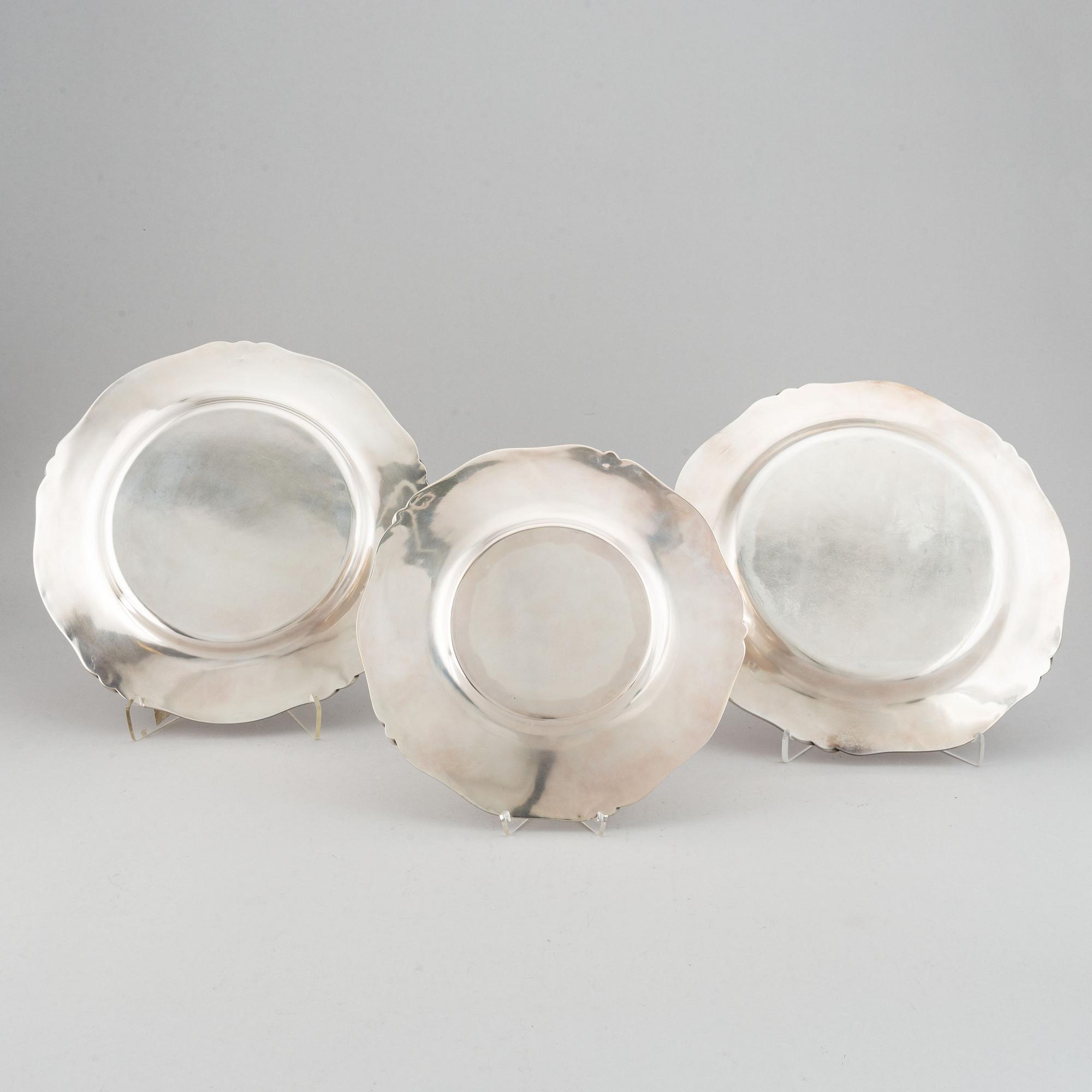 Three silver serving plates, decorated with "knots", Swedish import marks.