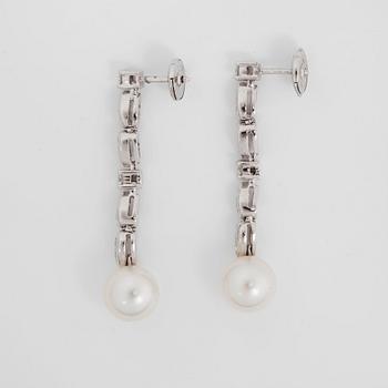 A pair of Boucheron diamond, 0.86 cts, and cultured pearl earrings.