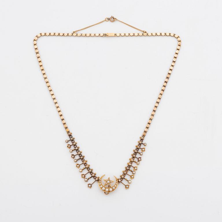 A gold necklace set with pearls.