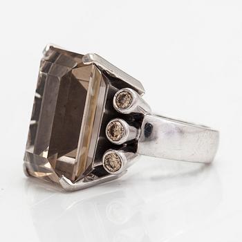 An 18K whitegold ring with an emeraldcut smokey quartz and diamonds approx 0.70 ct in total, Kultala, Helsinki 2008.
