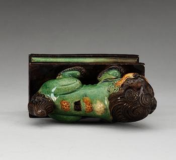 A green, yellow and aubergine glazed figure of a dog, Qing dynasty, 19th Century.