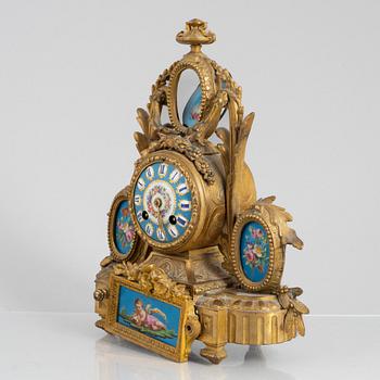 A Louis XVI style mantel clock and a pair of candelabra, circa 1900.