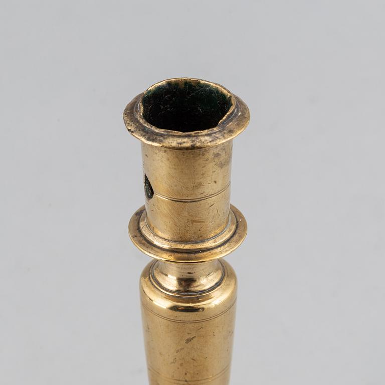 A 17th century bronze candlestick.