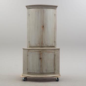 An 18th century painted corner cabinet.