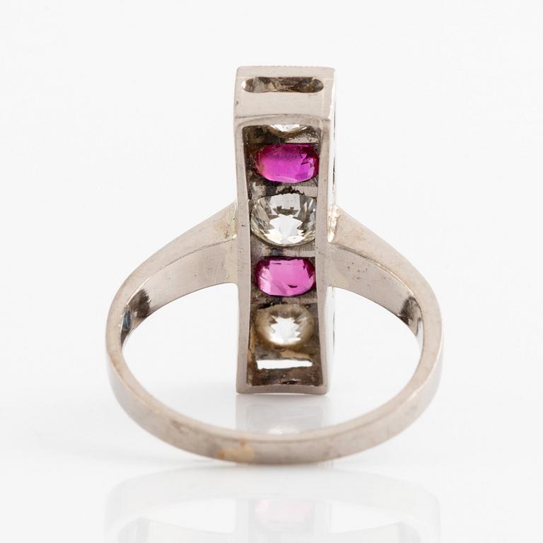 An 18K white gold ring set with faceted rubies and old-cut diamonds.