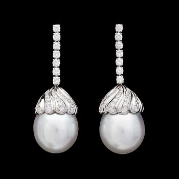 A pair of cultured South sea pearl, 14,4 mm, and brilliant cut diamond earrings, tot, app. 1.45 cts.