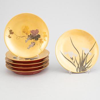 A set of six lacquered and painted Japanese plates, 20th Century.