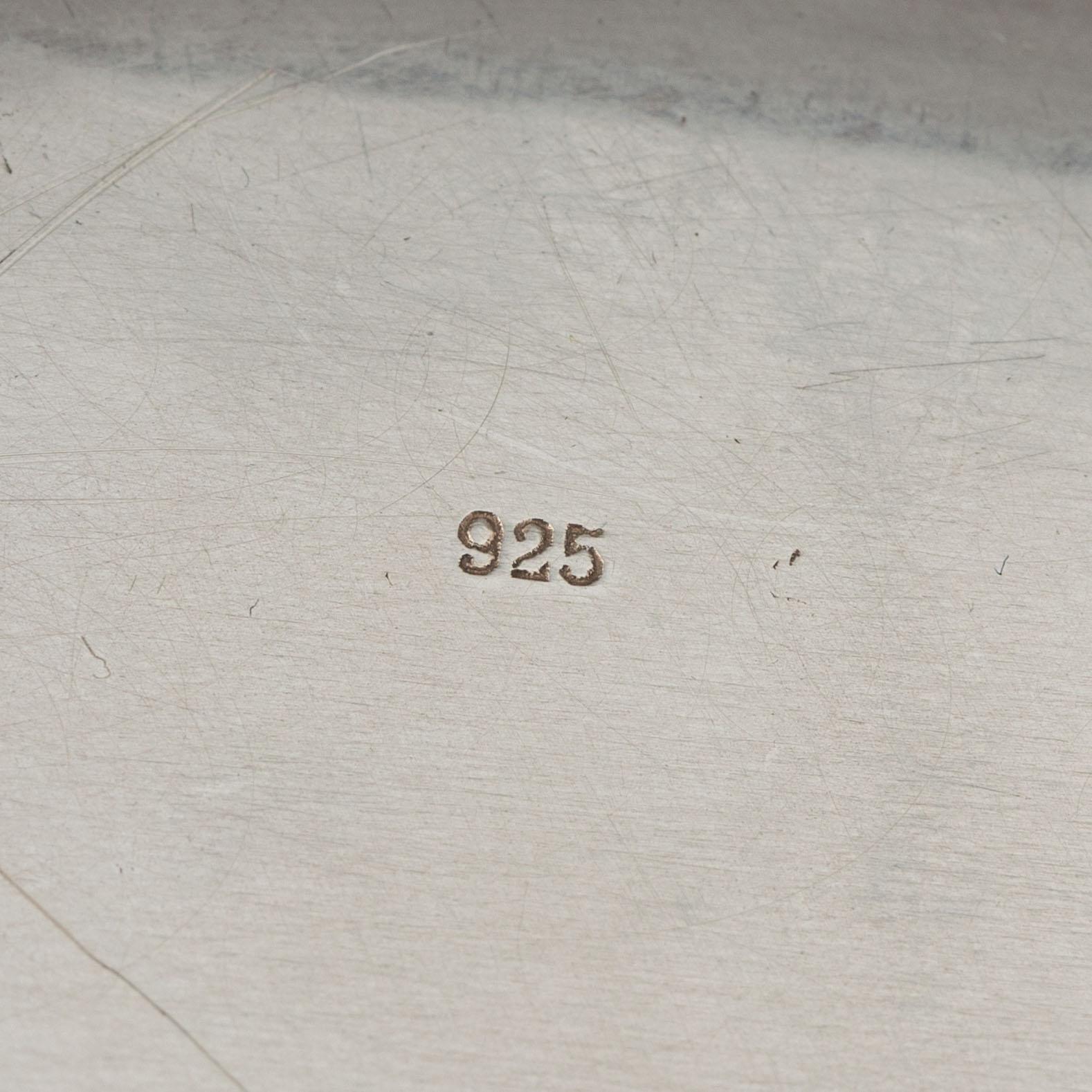 Three silver serving plates, decorated with "knots", Swedish import marks.