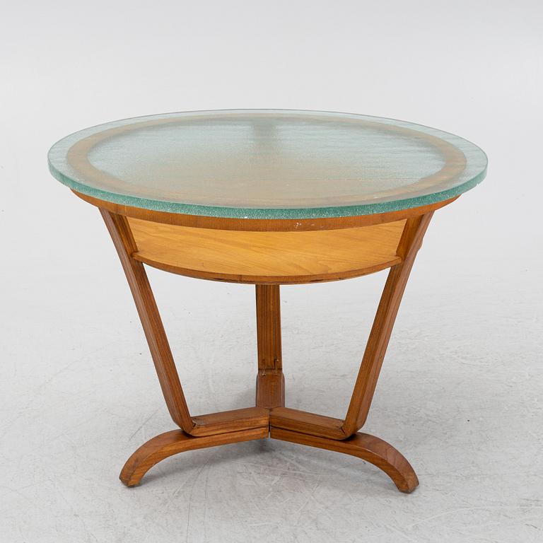 A Swedish Modern coffee table with a glass top. 1940's.