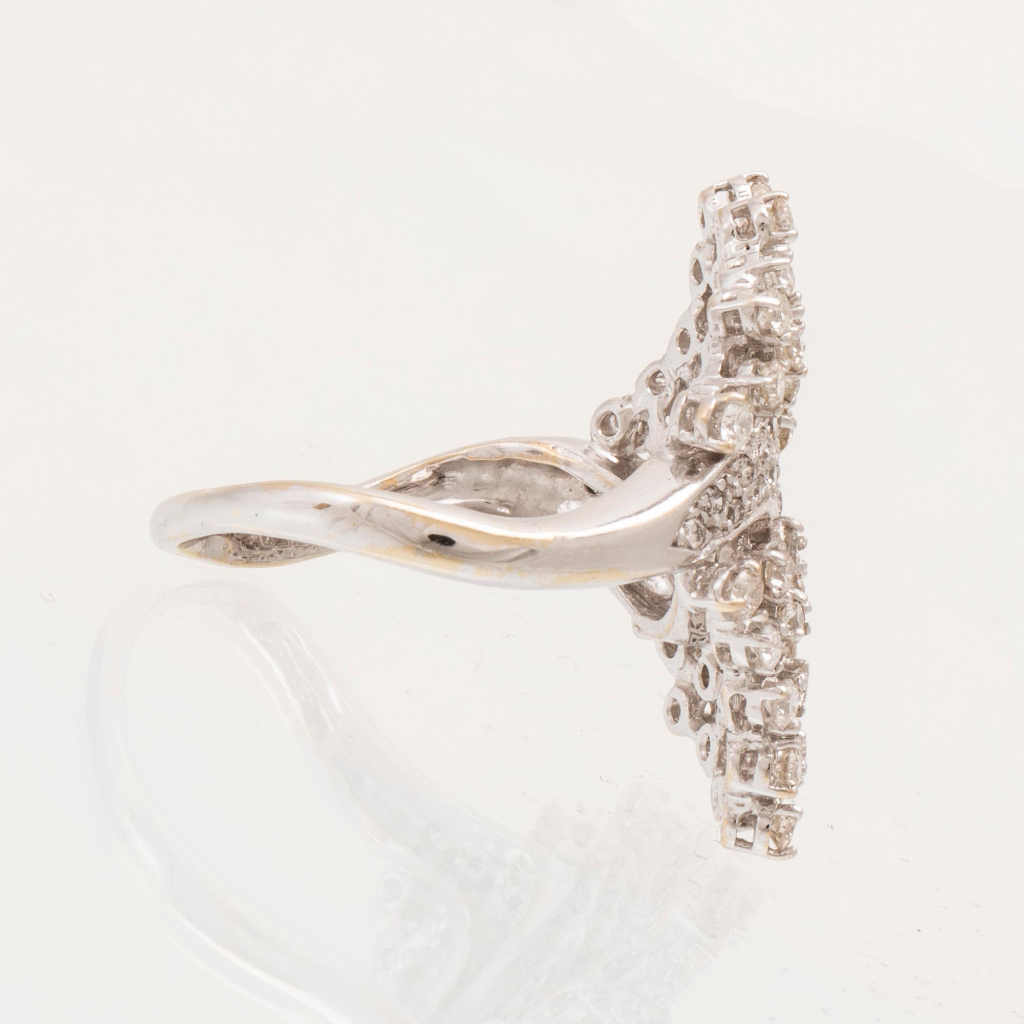 An 18K white gold ring set with round brilliant cut diamonds.