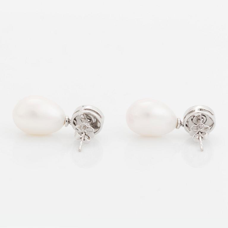 A pair of 18K white gold and cultured pearls earrings set with round brilliant-cut diamonds.