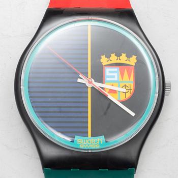 A wall clock, Swatch.