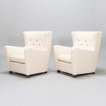 A pair of mid-20th-century armchairs.