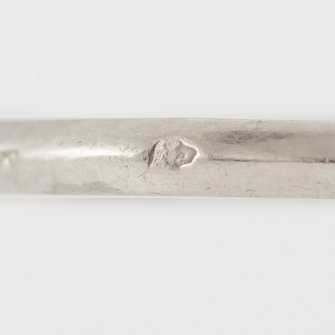 Platinum ring with sapphire and old-cut diamonds.