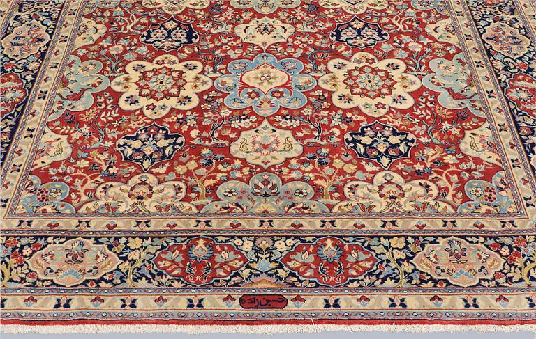 A Sarouk carpet, signed, approx. 327 x 253 cm.