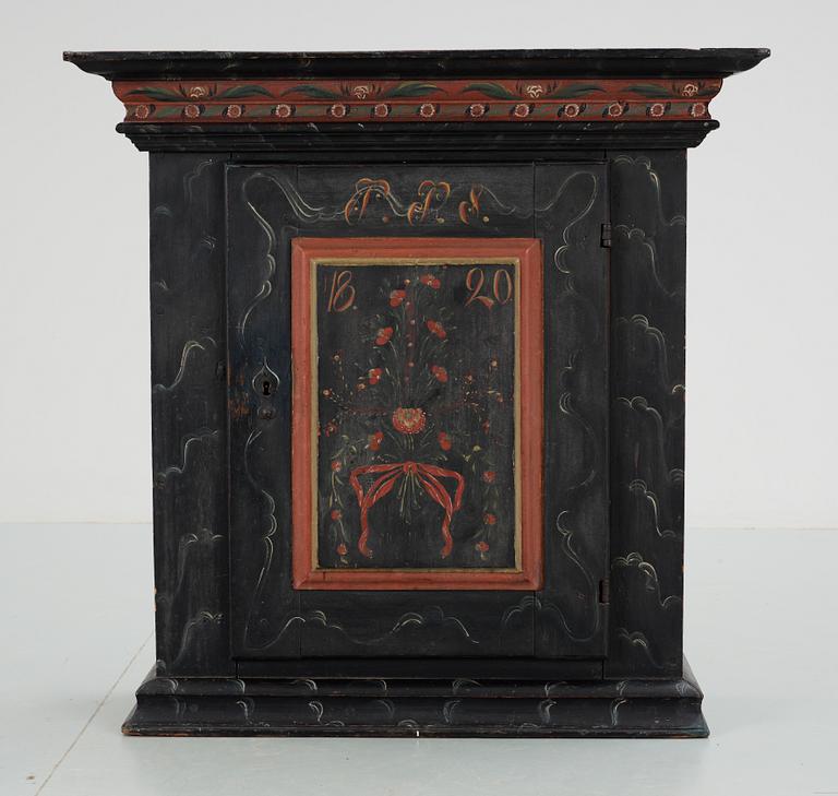 A Swedish wall cabinet, dated 1820.