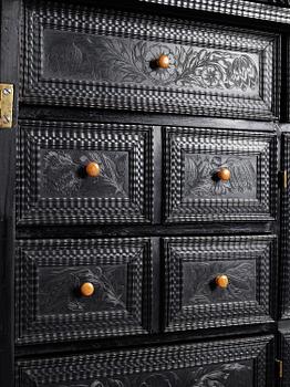 A Louis XIV and Louis XIV-style carved ebony, ivory and tortoiseshell-inlaid cabinet on stand, 17th and 19th century.