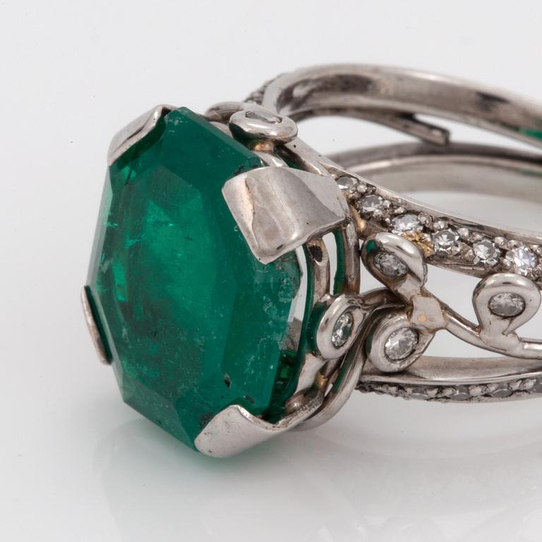 An octagonal cut 6.50 ct emerald and brilliant cut diamond ring. Mandelstam 'Ice Age'.