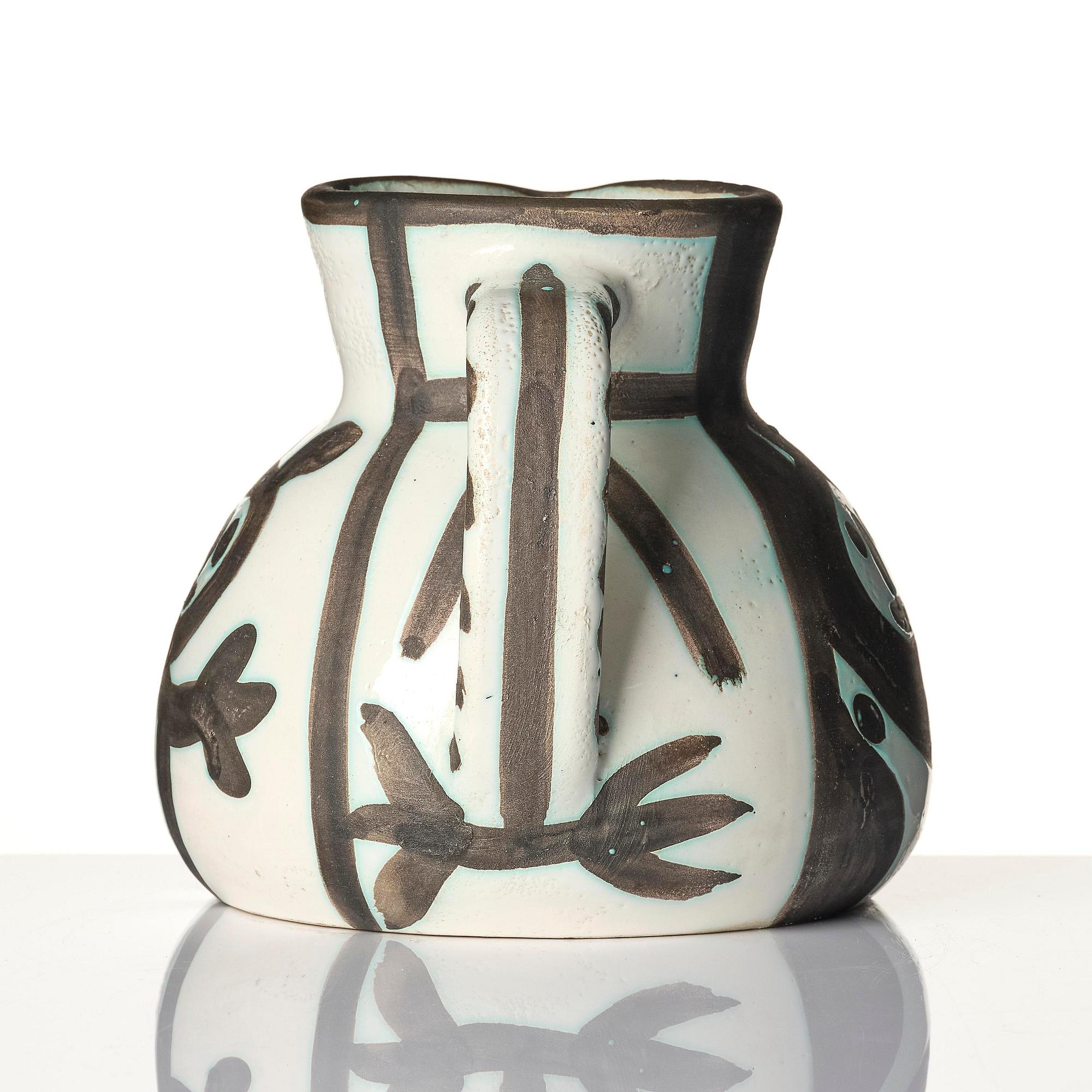 Pablo Picasso, a "Pichet petites têtes" (A.R. 222) faience pitcher, Madoura, Vallauris, France, post 1953.