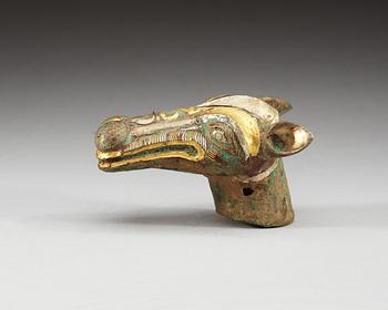 An archaistic bronze handle for a cane in the shape of a mythological animal.