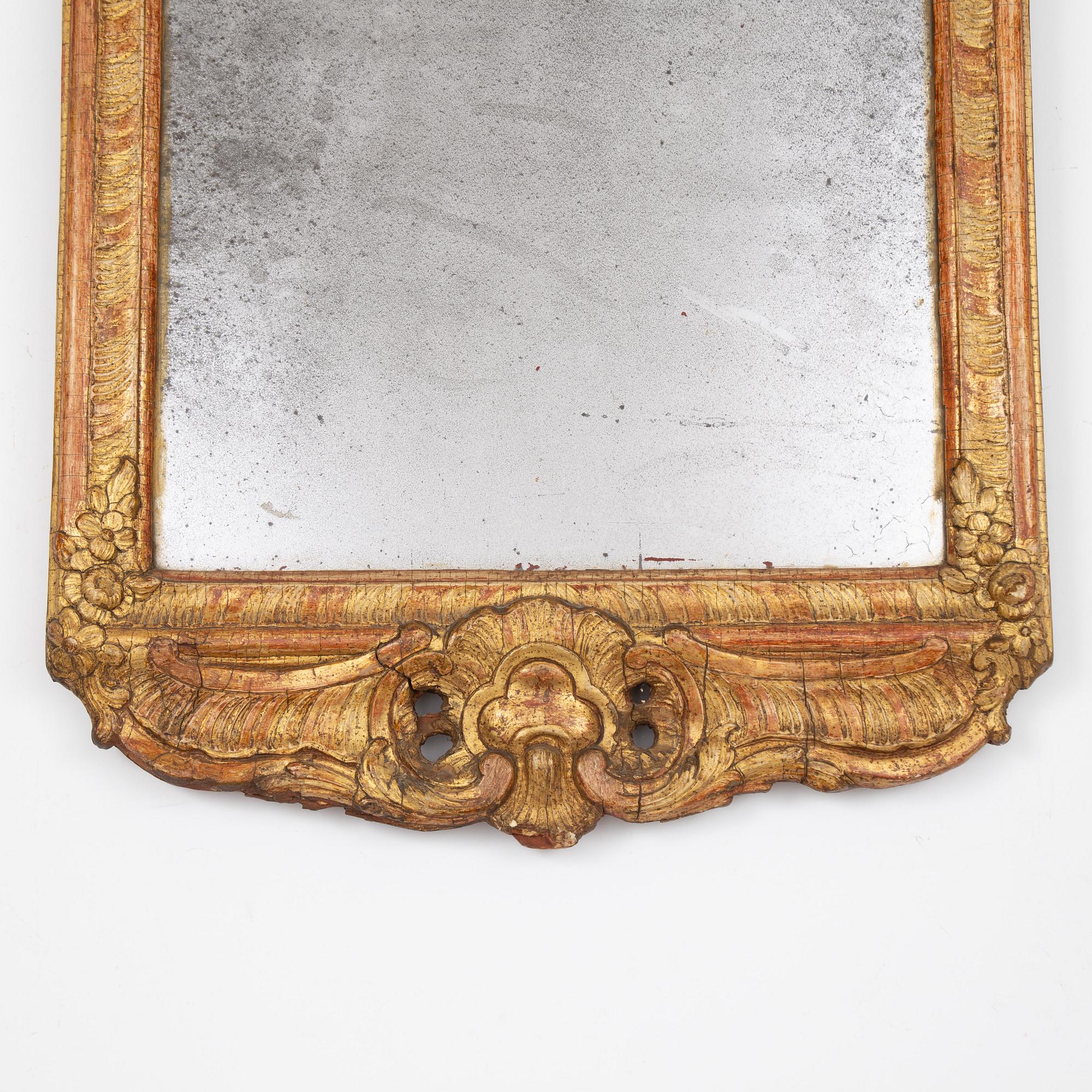 A Swedish rococo giltwood mirror in the manner of E. Göbel, Stockholm, later part 18th century.