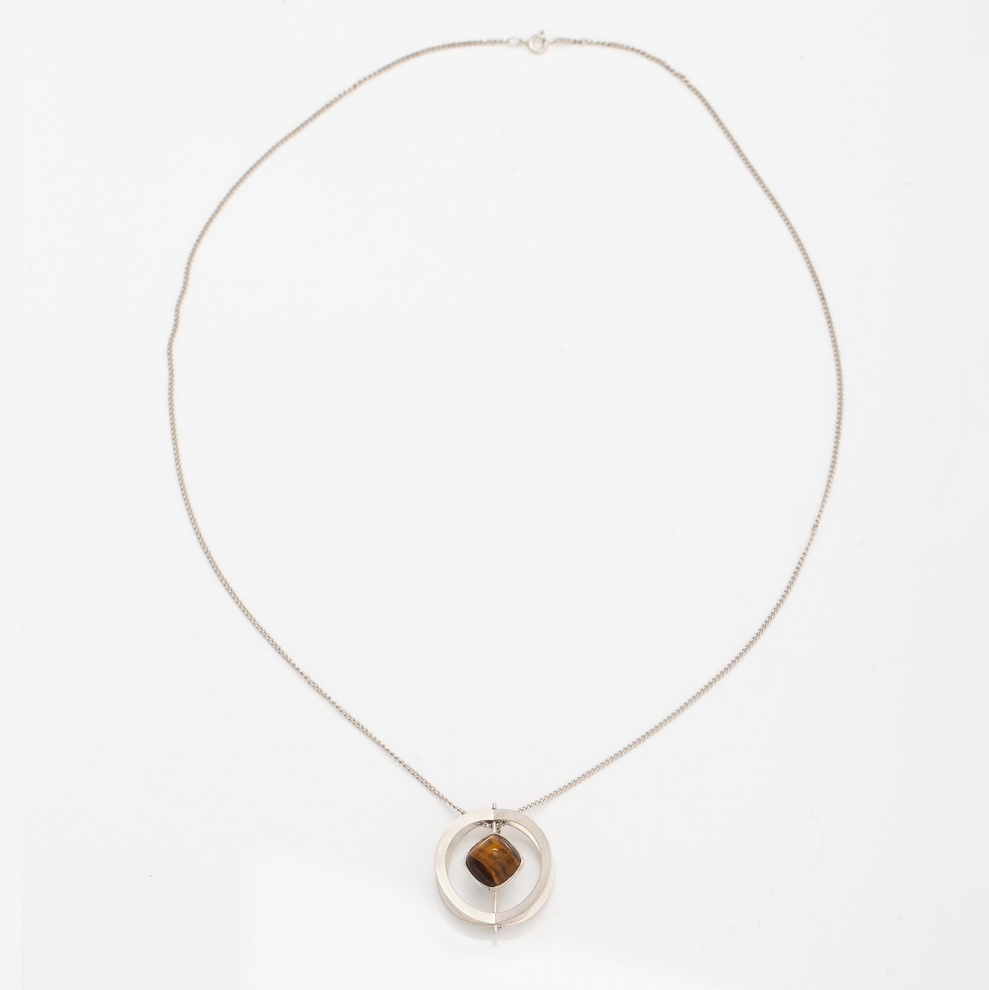 Elis Kauppi, A silver necklace/brooch with a tiger's eye. Kupittaan kulta, turku 1961.