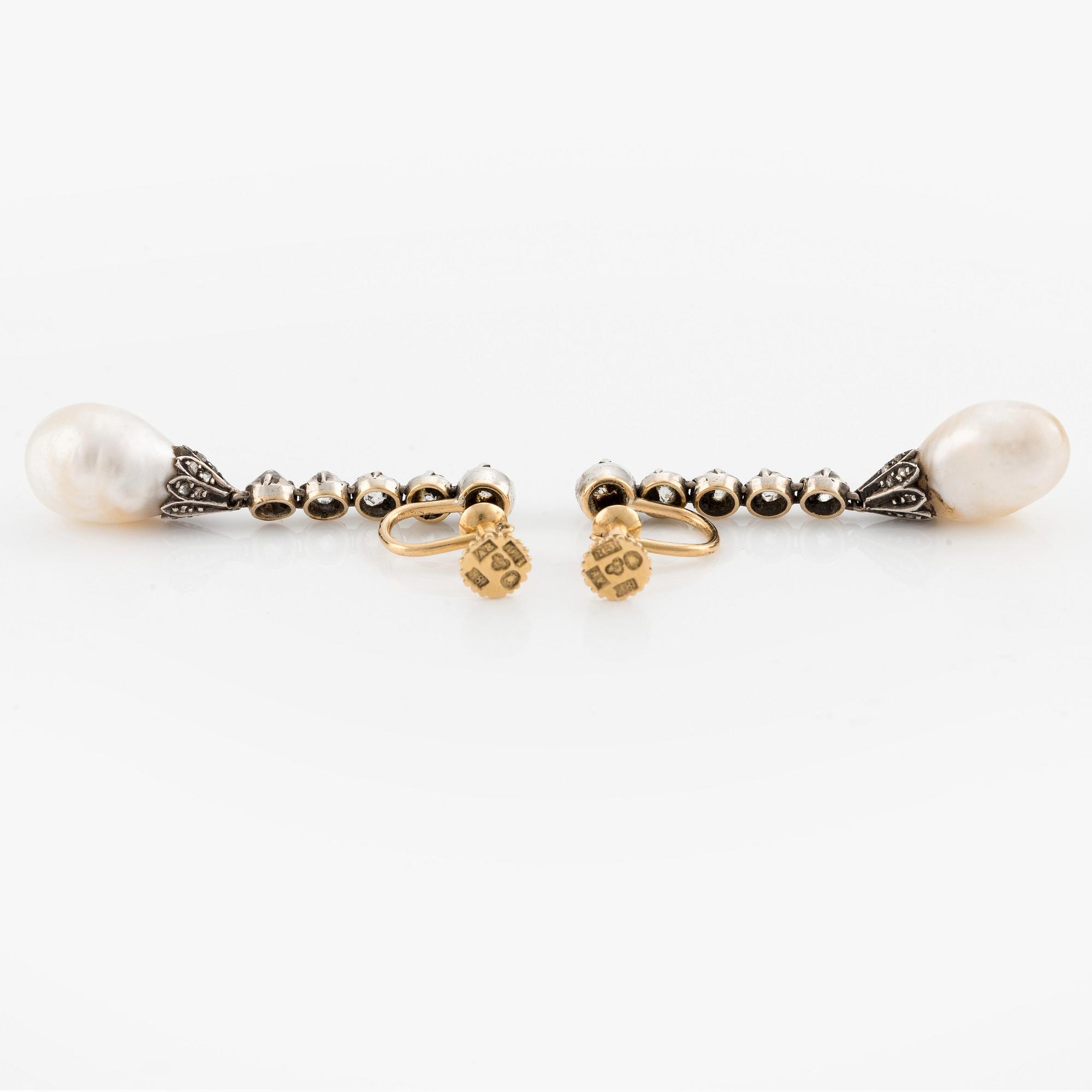 A pair of silver and gold earrings with drop-shaped pearls and old- and rose-cut diamonds.