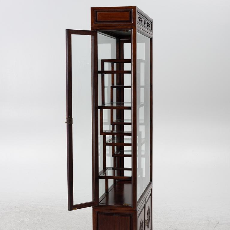 A Chinese display cabinet, wood and glass, later part of the 20th century.