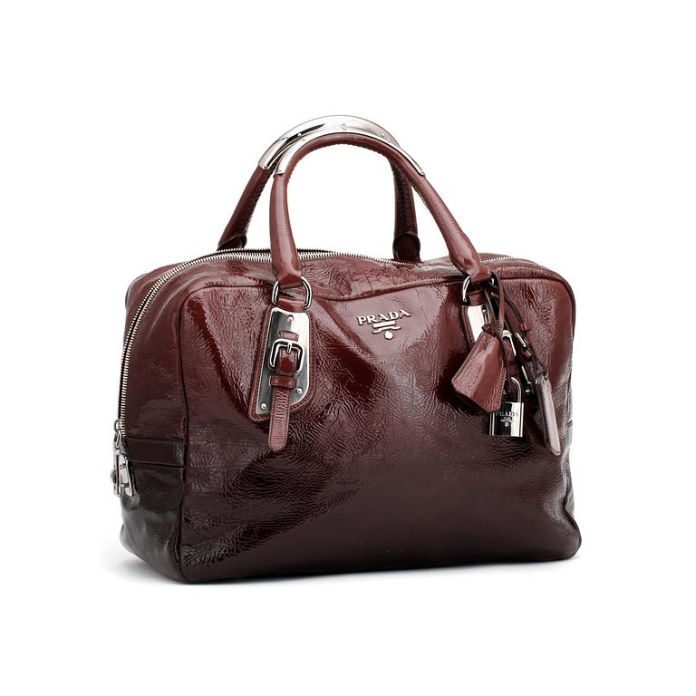PRADA, a brown leather glace zipper bag.