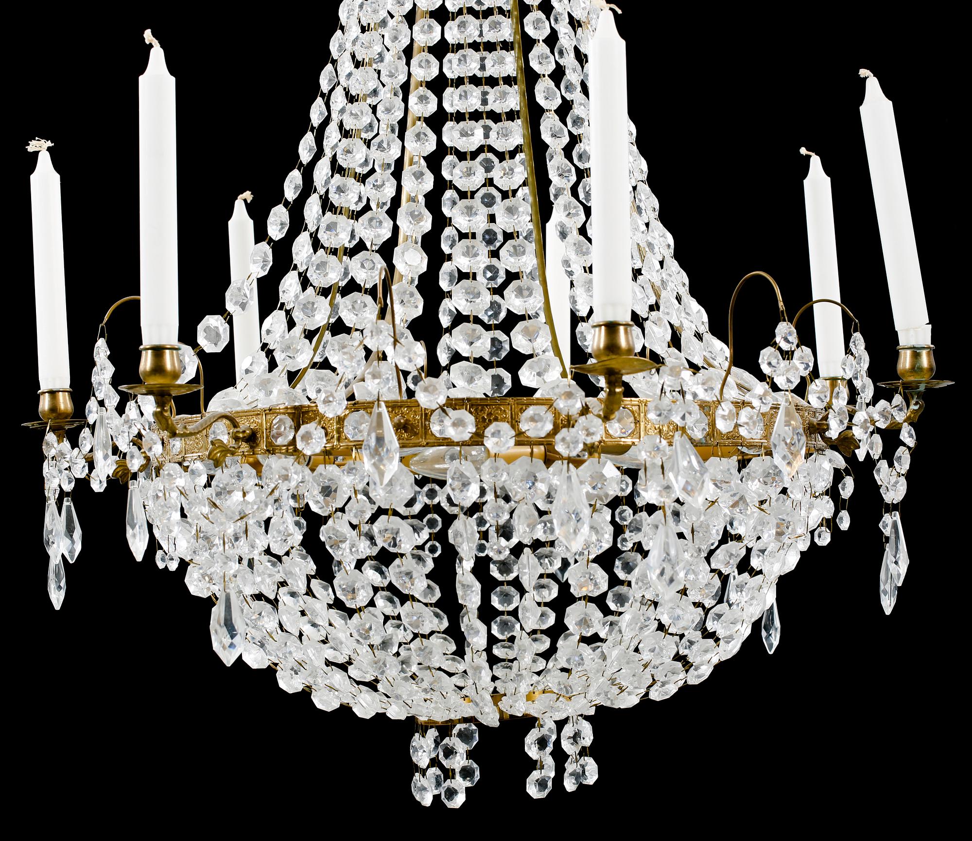 A 20th century chandelier in the Empire style. Height ca 96 cm.